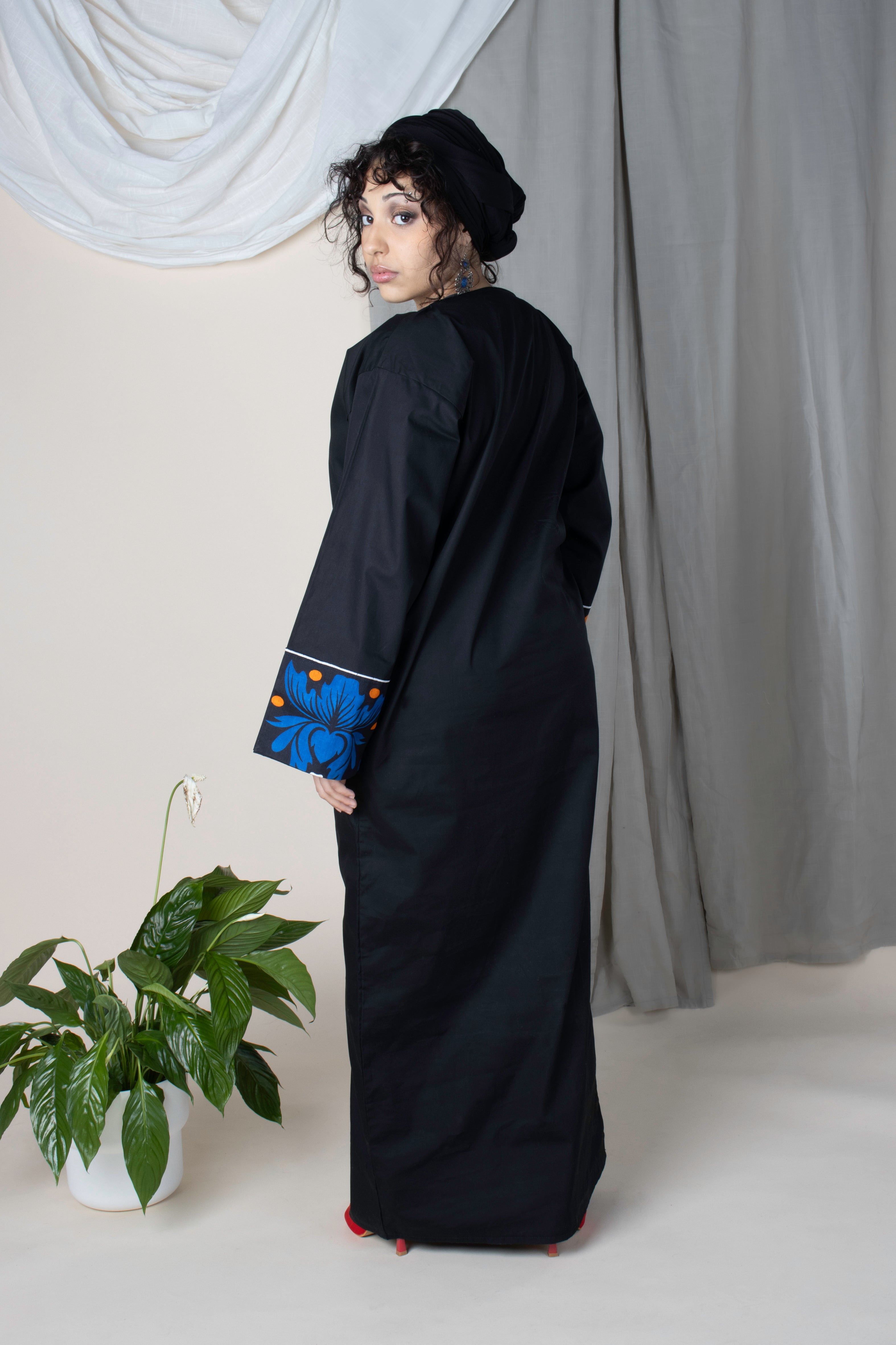 Robe noire en coton Iconi II avec poignets en tissu comorien fleuri bleu
